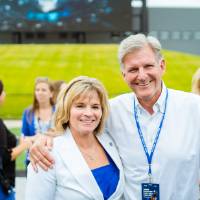 Guests posing with arms around one another at the Jamie Hosford Football Center dedication.